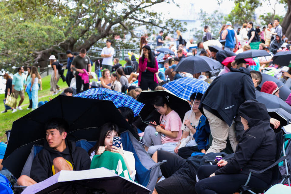 Crowds gathered as light rain fell in Sydney for New Year's Eve celebrations. Source: Getty