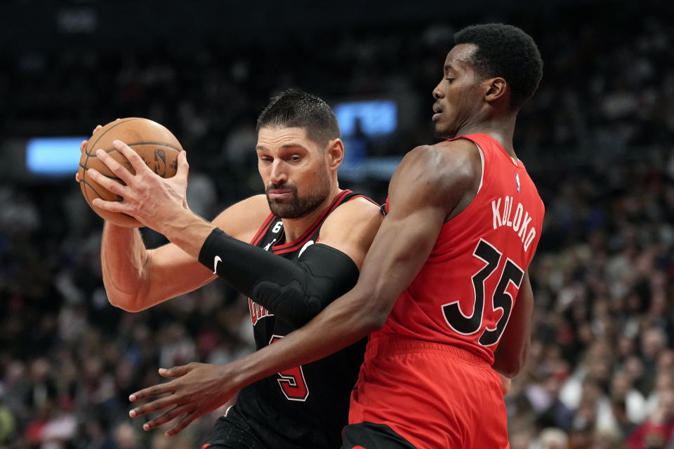 Toronto Raptors forward Christian Koloko (35) blocks Chicago Bulls center Nikola Vucevic (9) during first-half NBA basketball game action in Toronto, Sunday, Nov. 6, 2022. (Frank Gunn/The Canadian Press via AP)