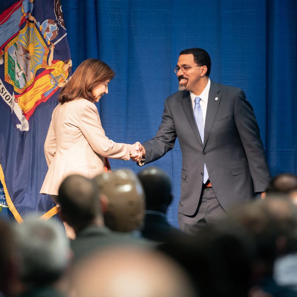 New York State Governor Kathy Hochul shakes hands with SUNY Chancellor John B. King, Jr. after announcing the state is investing $44 million in the health and advanced manufacturing programs at SUNY Polytechnic Institute in Marcy, NY on Friday, November 17, 2023.