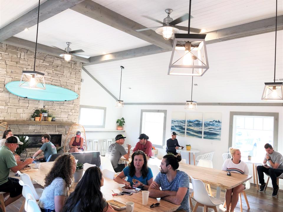 Customers packed into the new Mahalo Coffee Roasters on opening day, July 6, 2019. “We have seen so many coffee shops with community tables and we wanted to create that environment,” said owner Trevor Bayne.