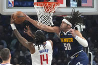 Los Angeles Clippers guard Terance Mann, left, shoots as Denver Nuggets forward Aaron Gordon defends during the first half of an NBA basketball game Thursday, April 4, 2024, in Los Angeles. (AP Photo/Mark J. Terrill)