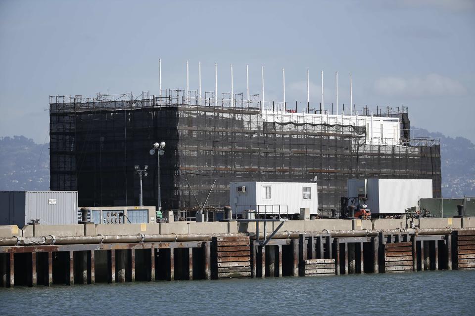 A barge built with four levels of shipping containers is seen at Pier 1 at Treasure Island in San Francisco, California October 28, 2013. How badly does Google want to keep under wraps a mysterious project taking shape on a barge in San Francisco Bay? Badly enough to require U.S. government officials to sign confidentiality agreements. REUTERS/Stephen Lam (UNITED STATES - Tags: SCIENCE TECHNOLOGY BUSINESS)