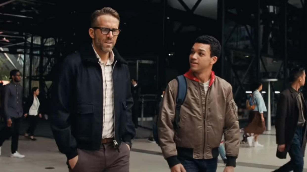  Ryan Reynolds and Justice Smith walking together from the train station in Pokémon Detective Pikachu. 