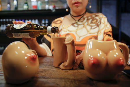 27-year-old Lu Lu, the owner of Ke'er restaurant (Shell in English), pours a drink into a penis-shaped cup at her restaurant in Beijing, China, May 26, 2016. REUTERS/Kim Kyung-Hoon