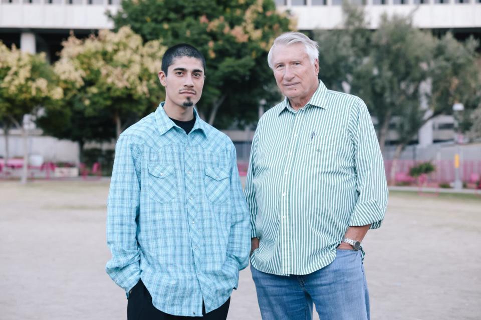 Adrian Abelar poses for a portrait with his lawyer Thomas Beck