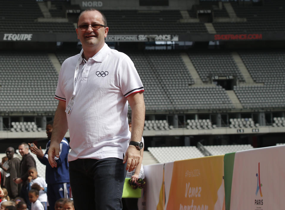 FILE - In this Monday May 15, 2017 file photo, International Olympic Committee Evaluation Commission Chair Patrick Baumann smiles as he visits the Stade de France stadium, in Saint-Denis, outside Paris. Baumann is part of a nine-person group announced Saturday, April 4, 2020, as this year’s class of enshrinees into the Naismith Memorial Basketball Hall of Fame. (AP Photo/Michel Euler, file)