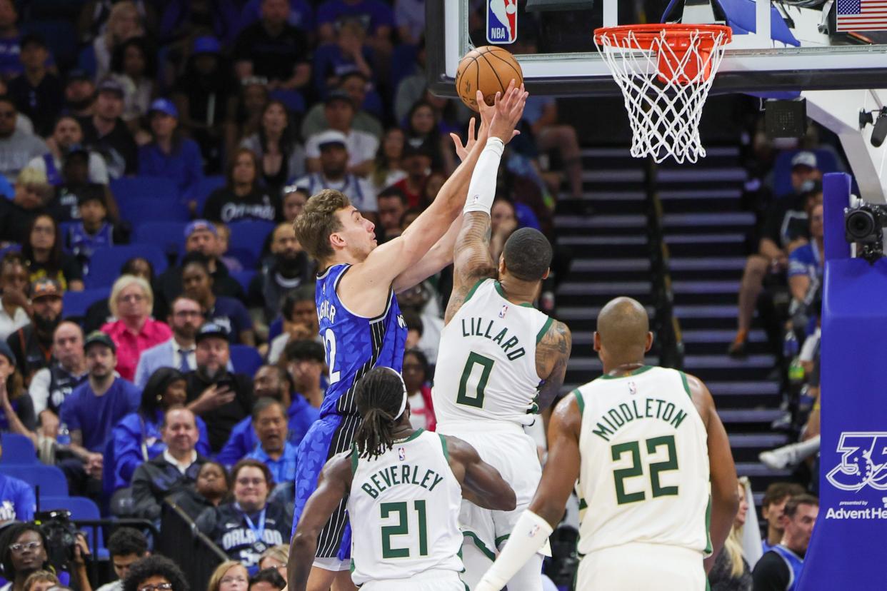 Magic forward Franz Wagner goes up for a shot as Bucks guard Damian Lillard attempts to deny him during the second quarter Sunday.
