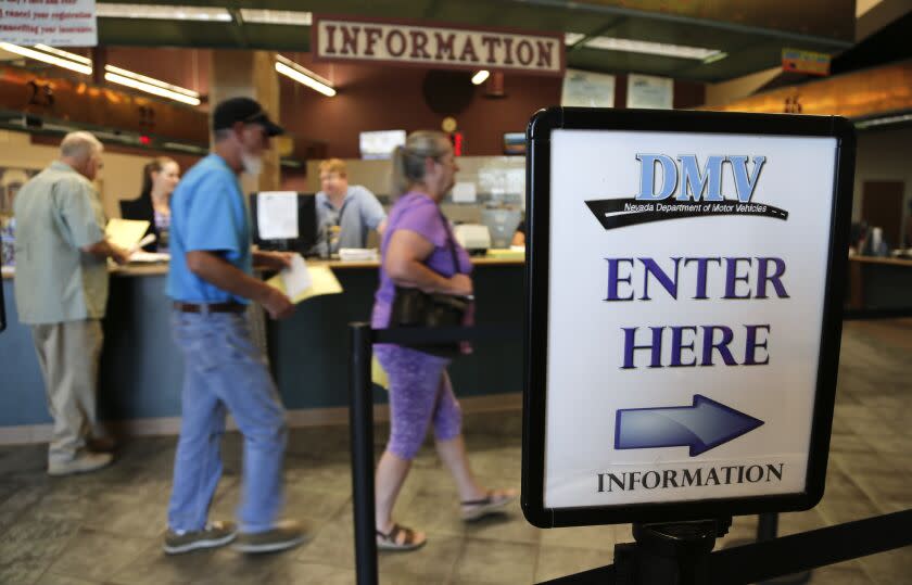 Las Vegas and Henderson, Nev. residents enter the Department of Motor Vehicles to renew vehicle registration and drivers licenses, Wednesday, Aug. 7, 2013, in Las Vegas. The Nevada state Department of Motor Vehicles is working on rules to determine what kind of residency paperwork will be accepted from tens of thousands of people who are expected to seek state driver privilege cards for the first time after Jan. 1. The state Legislature passed a law this year putting Nevada among several states letting people who don't have legal U.S. residency obtain driver authorization cards. (AP Photo/Julie Jacobson)