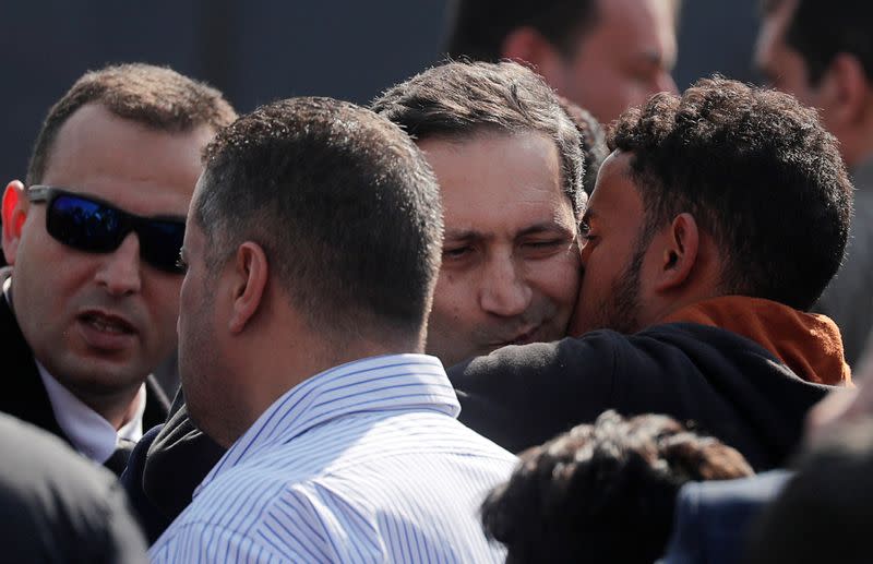 Alaa, son of former Egyptian President Hosni Mubarak, is kissed as he is consoled during his father's funeral east of Cairo,