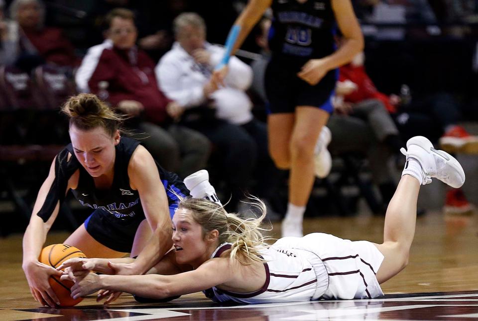 Missouri State Lady Bear Lacy Stokes fights for a loose ball against Brigham Young University at Great Southern Bank Arena in Springfield on December 20, 2023.