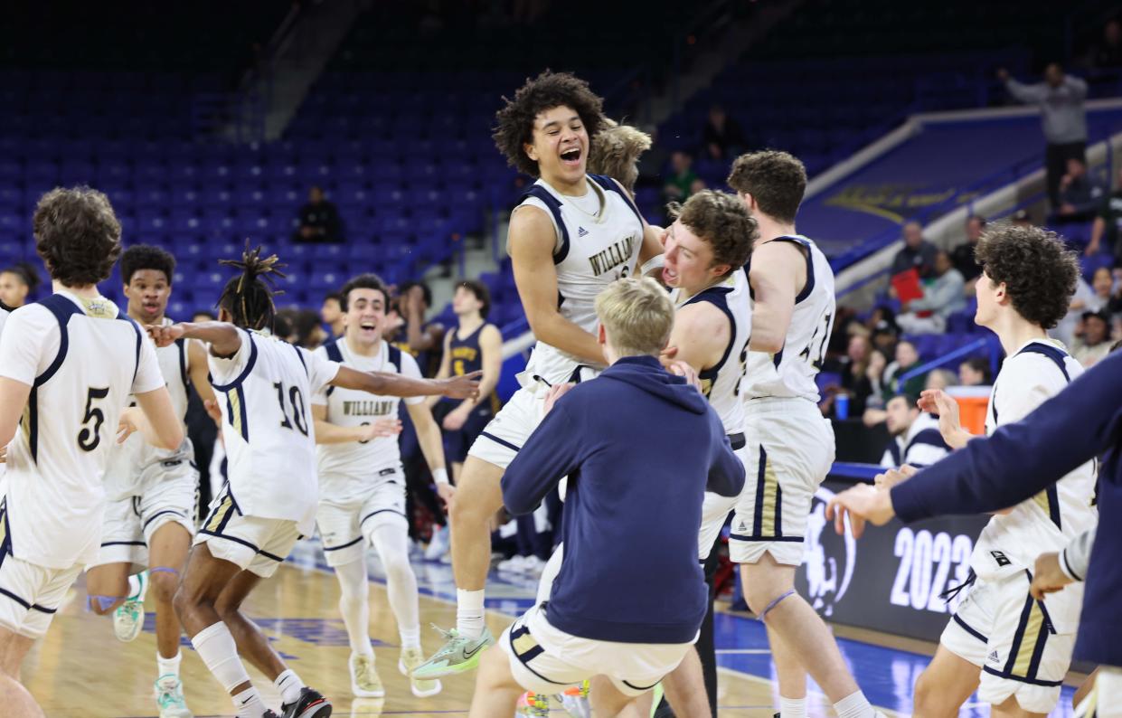 Archbishop Williams' Tristan Rodriguez and teammates celebrate at the conclusion of their MIAA Division 3 title game versus St. Mary's at the Tsongas Center in Lowell on Saturday, March 18, 2023.