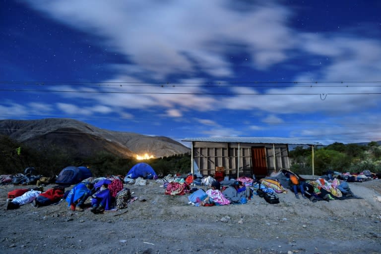 Venezuelan migrants on their way to Peru sleep along the Pan-American Highway between Tulcan and Ibarra in Ecuador, after entering the country from Colombia in August 2018 -- hundreds of thousands fled crisis in Venezuela this year