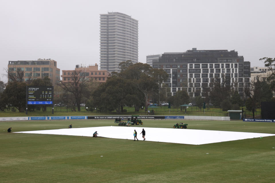 Groundsmen, pictured here covering up the field during a rain delay during the Marsh Cup match between Victoria and NSW.