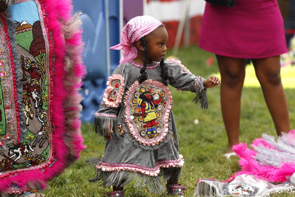 Jania Williams, 2, a Little Queen with the Cheyenne Mardi Gras Indian tribe, readies to parade with the tribe at the New Orleans Jazz and Heritage Festival in New Orleans, Thursday, May 3, 2012. (AP Photo/Gerald Herbert)