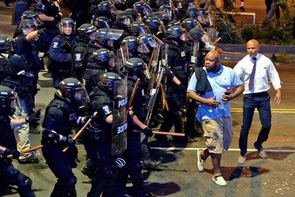 Toussaint Romain, right, gained prominence in 2016 during the unrest following the fatal CMPD shooting of Keith Scott Romain was a public defender at the time. Observer staff