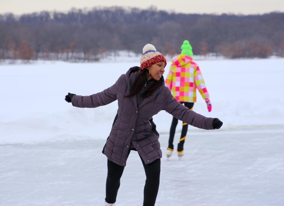 Ice skaters traverse one of the natural ice rinks on Kent Lake in Kensington Metropark