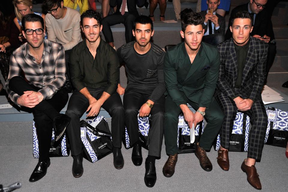 Colton Haynes is snapped at New York Fashion Week in 2013 next to his fellow actor Zachary Quinto, far left, and musicians Kevin, Joe and Nick Jonas.