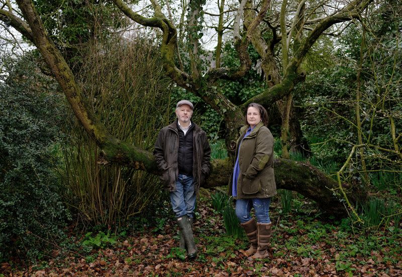 Retired couple Ian and Liz Woodbridge pose for a photograph in the garden of their home in Ellesmere