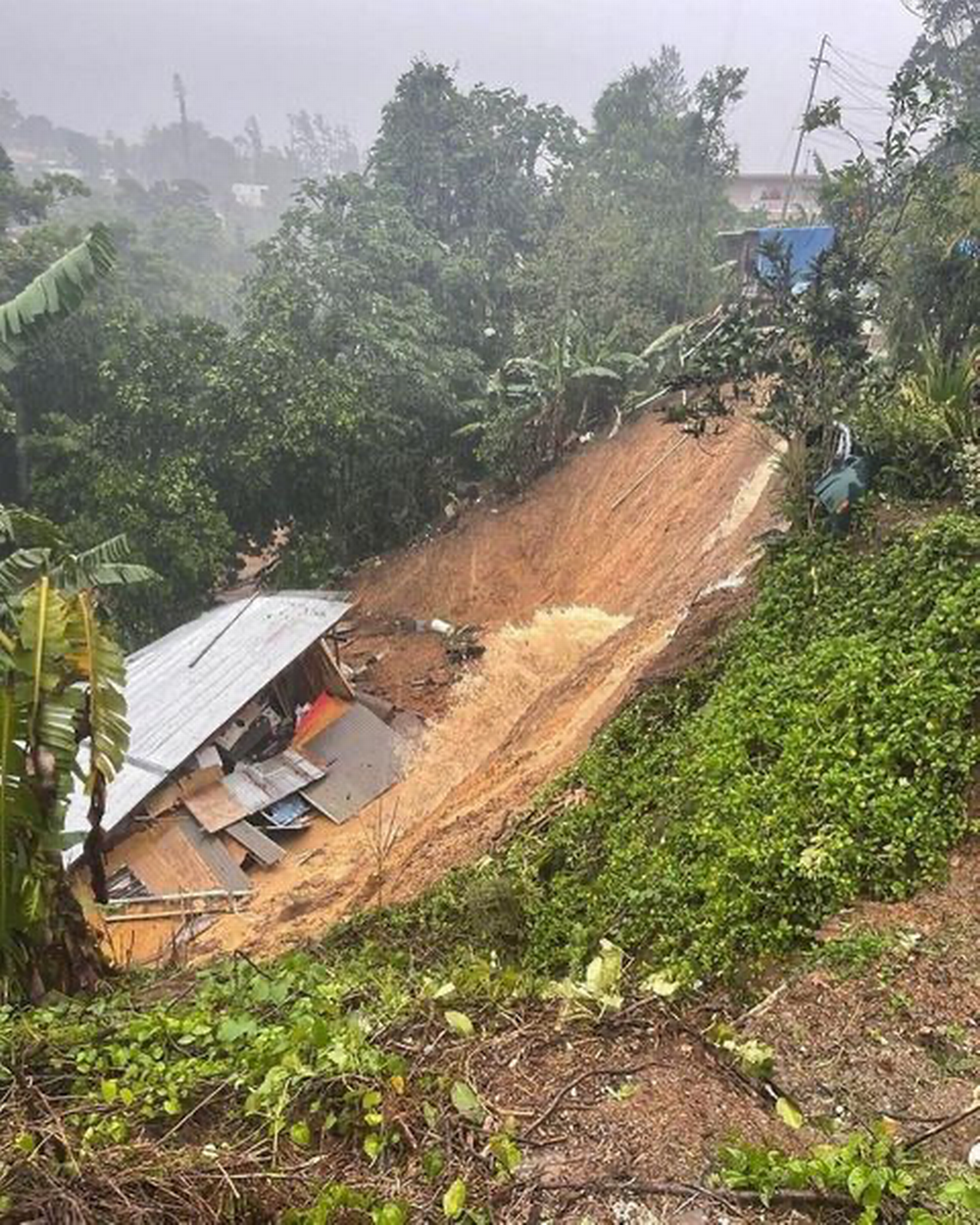 A landslide caused a house to collapse in the Puerto Rican town of Barranquitas on Sunday, Sept. 18, 2022.