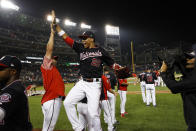 Washington Nationals' Juan Soto (22) jumps to celebrate with hitting coach Kevin Long after the team's baseball game against the Cincinnati Reds at Nationals Park, Tuesday, Aug. 13, 2019, in Washington. The Nationals won 3-1. (AP Photo/Alex Brandon)