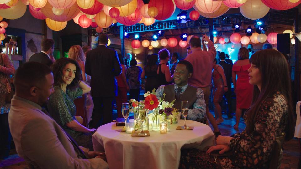 NCIS team members Quentin Carter (Charles Michael Davis), left, Hannah Khoury (Necar Zadegan), Patton Plame (Daryl "Chill" Mitchell) and Tammy Gregorio (Vanessa Ferlito) relax at the wedding reception for Pride and Rita in the series finale of "NCIS: New Orleans."