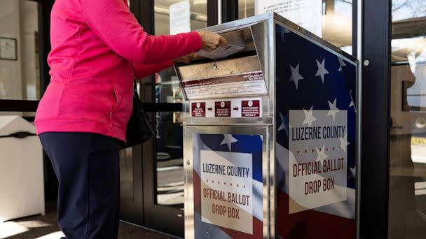 PHOTO: In this Nov. 3, 2022, file photo, a Luzerne County resident drops off a mail-in ballot in Wilkes-Barre, Penn. (Hannah Beier/Reuters, FILE)