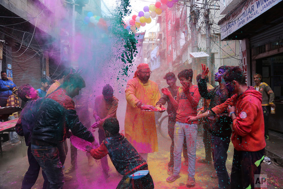 <p>Indians play with coloured powder during Holi festival celebrations in Jammu, India. Holi, the Hindu festival of colours, also heralds the coming of spring. (AP Photo/Channi Anand) </p>