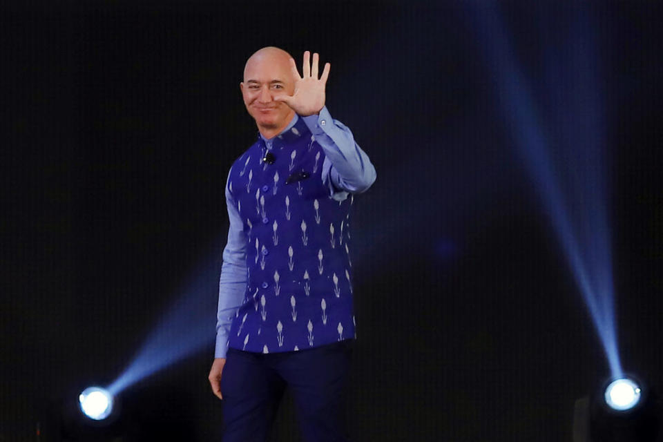 Jeff Bezos, founder and chief executive officer of Amazon.com Inc., waves during the opening session of Amazon Sambhav event in New Delhi, India, on Wednesday, Jan. 15, 2020. Bezos got a bitter reception during his India visit this week after the country's antitrust regulator initiated a formal investigation hours before his arrival and infuriated small store owners demonstrated in the streets.