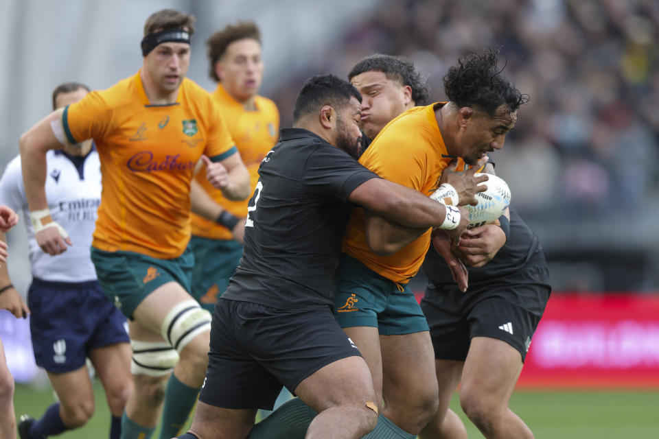 Wallabies Pone Fa'amausili is tackled by New Zealand's Samisoni Taukei'aho during the Bledisloe Cup rugby test match between the All Blacks and Australia in Dunedin, New Zealand, Saturday, Aug. 5, 2023. (Derek Morrison/Photosport via AP)