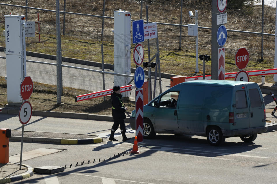 A Russian border guard officer checks a car at Pelkola border crossing point in Imatra, south-eastern Finland, Friday, April 14, 2023. (AP Photo/Sergei Grits)