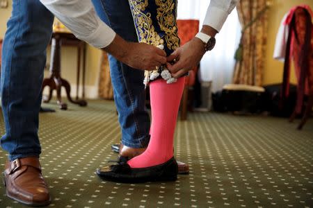 Alberto Lamelas is helped for dressing by his aide Angel Gomez in a hotel room before taking part in a bullfighting during San Isidro festival at Las Ventas bullring in Madrid, Spain, June 5, 2017. REUTERS/Sergio Perez