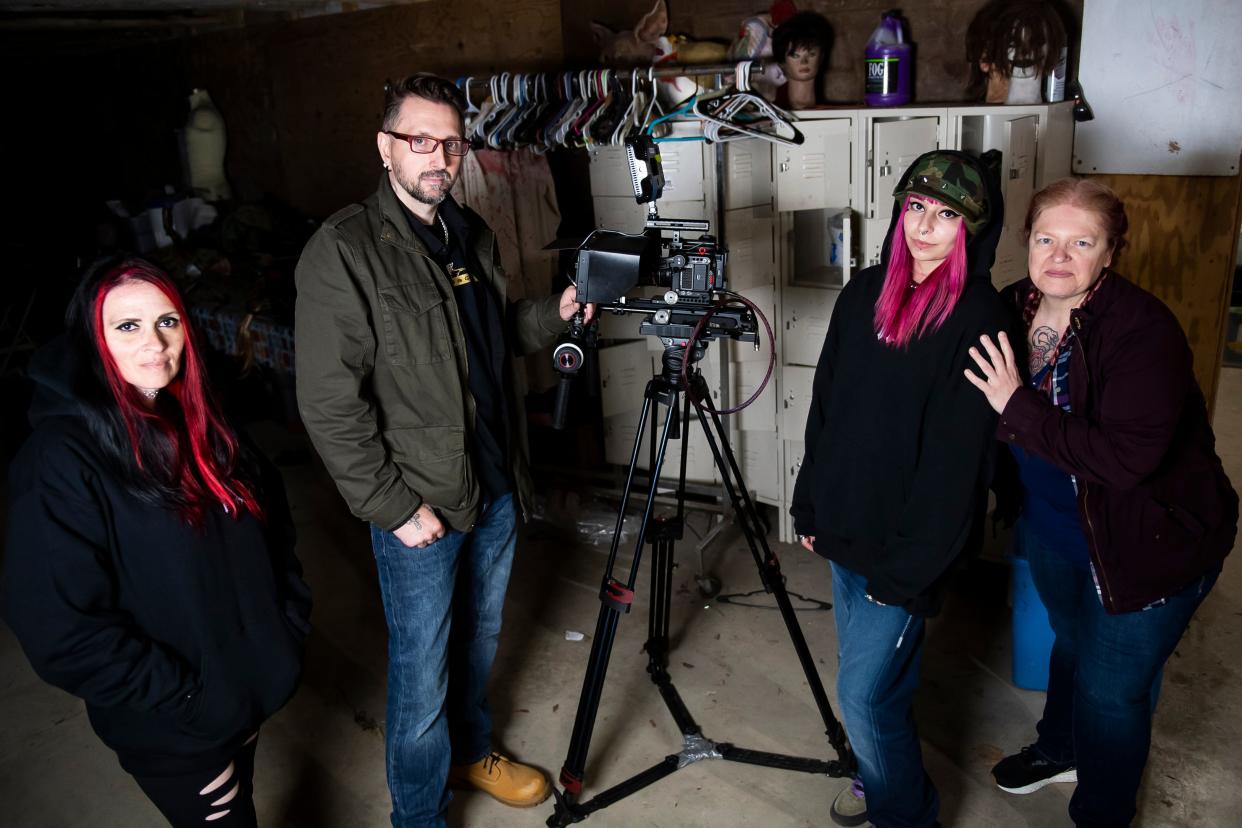 "Dark Echoes Paranormal" investigators pose for a group photo in the basement of "The House of Eyes" before filming an episode at Kim's Krypt Haunted Mill in Heidelberg Township on April 12, 2024. The four investigators are (from left) sound mixer Tammy Lee, director, host and owner Matthew Ryan Kondracki, cinematographer Scarlett Zajac and public relations director Stacy Reed.
