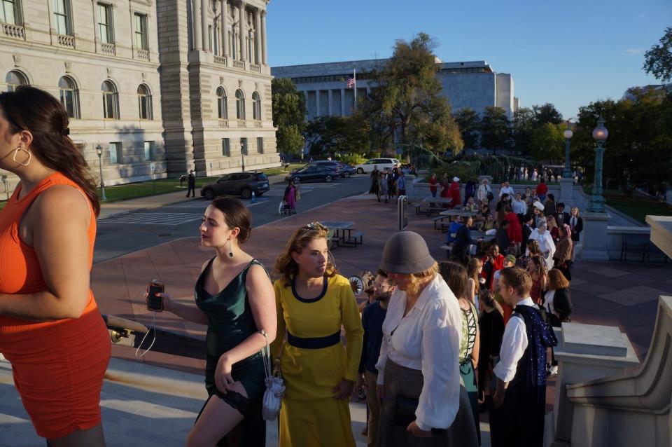 Attendees at the Library of Congress' Literary Costume Ball line up outside the building.