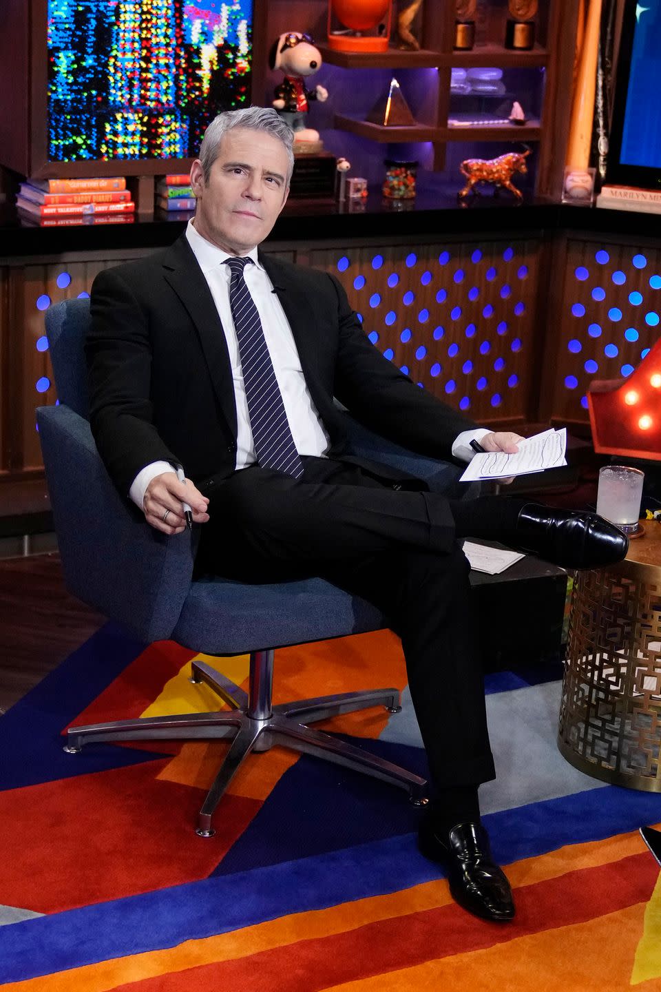 andy cohen sitting in a chair on watch what happens live