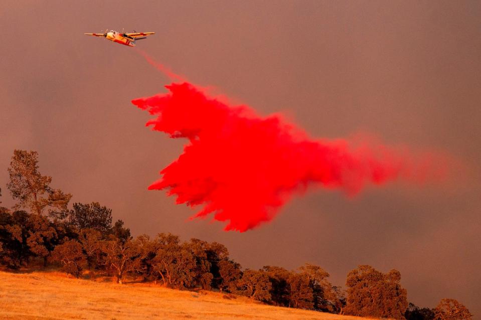 PHOTO: An air tanker drops retardant while battling the Aero Fire in the Copperopolis community of Calaveras County, Calif., June 17, 2024.  (Noah Berger/AP)