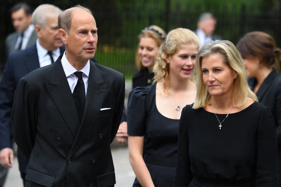 Britain's Prince Andrew, Duke of York (L), Britain's Prince Edward, Earl of Wessex (2L), Britain's Princess Eugenie of York (C), Britain's Lady Louise Windsor (3R), Britain's Sophie, Countess of Wessex (2R) and Britain's Princess Eugenie of York react as they look at the flowers placed outside Balmoral Castle in Ballater, on September 10, 2022, two days after Queen Elizabeth II died at the age of 96. - King Charles III pledged to follow his mother's example of 