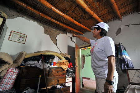 A woman is seen in a building after a strong magnitude 7.1 earthquake struck the coast of southern Peru, in Acari, Arequipa , Peru, January 14, 2018. REUTERS/Diego Ramos