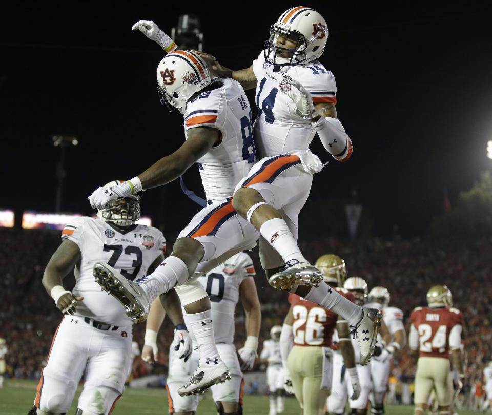 Auburn's Nick Marshall (14) congratulates Melvin Ray (82) after Ray's touchdown catch during the first half of the NCAA BCS National Championship college football game against Florida State Monday, Jan. 6, 2014, in Pasadena, Calif. (AP Photo/Chris Carlson)