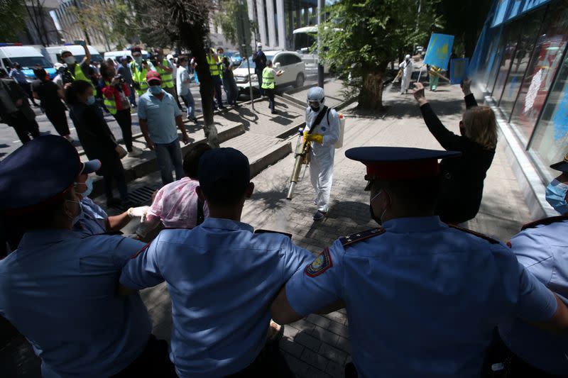 Kazakh law enforcement officers stand guard during an opposition rally in Almaty