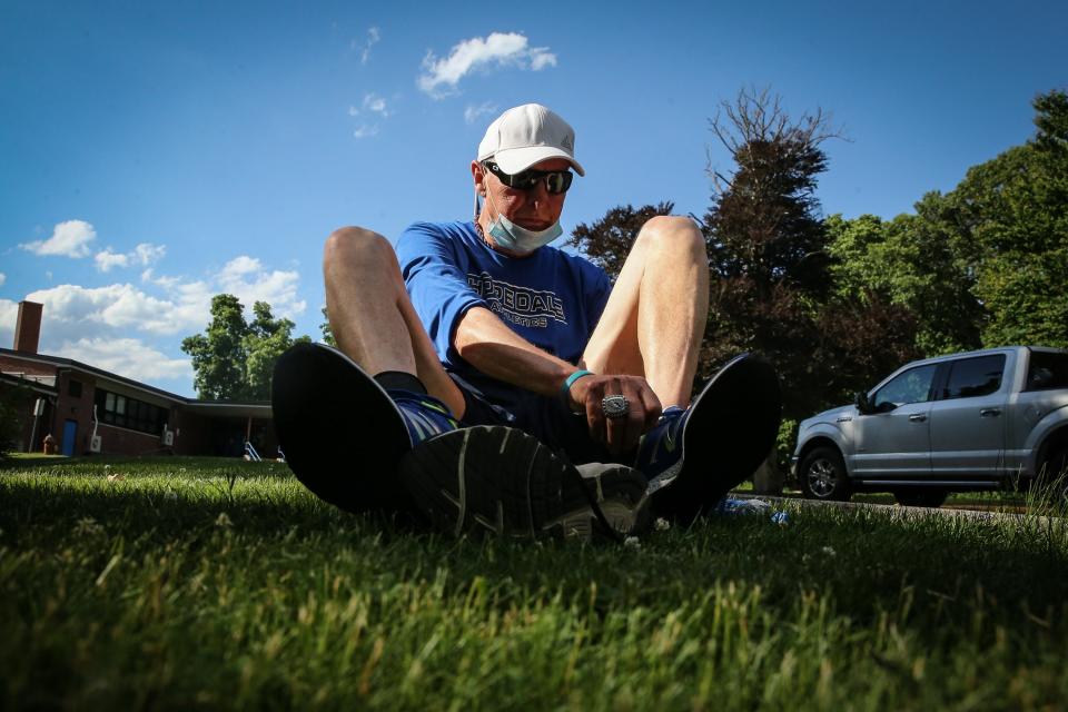 Hopedale High running coach Joe Drugan put his shoes on in preparation to run the "Crush Corona" 5K starting at Hopedale Memorial Elementary School in June 2020.