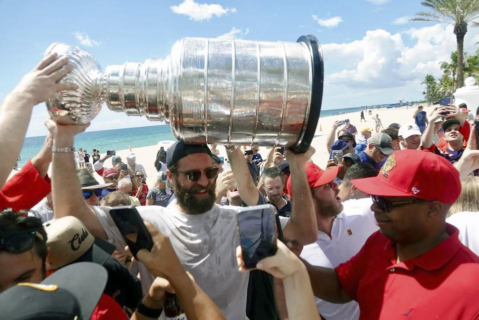 Florida Panthers NHL hockey player Aaron Ekblad carries the Stanley Cup in Fort Lauderdale, Fla., Tuesday, June 25, 2024. The Panthers beat the Edmonton Oilers 2-1 on Monday night in Game 7 of the Stanley Cup Final. (Joe Cavaretta/South Florida Sun-Sentinel via AP)