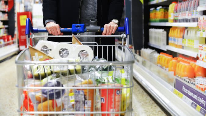 London, UK - December 12, 2014: A shopper browses an aisle of a Tesco supermarket store.