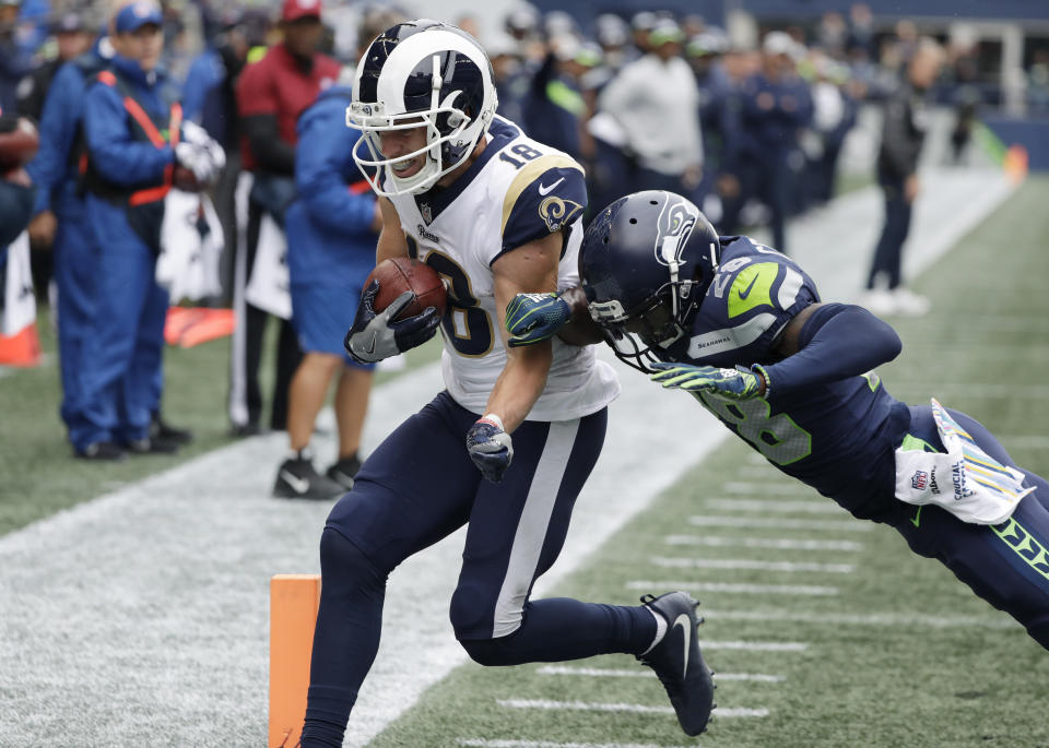 Los Angeles Rams wide receiver Cooper Kupp (18) scores a touchdown ahead of Seattle Seahawks cornerback Justin Coleman, right, during the first half of an NFL football game, Sunday, Oct. 7, 2018, in Seattle. (AP Photo/Elaine Thompson)