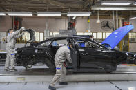 In this Feb. 17, 2020, file photo released by Xinhua News Agency, workers assemble Audi A6 L cars at a workshop of FAW-Volkswagen Automobile Co., Ltd. in Changchun, northeast China's Jilin Province.Factories that make the world's smartphones, toys and other goods are struggling to reopen after a virus outbreak idled China's economy. But even with the ruling Communist Party promising help, companies and economists say it may be months before production is back to normal. (Zhang Nan/Xinhua via AP, File)