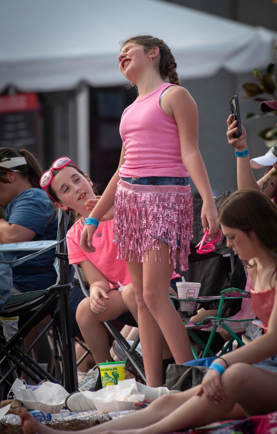 Laynie-Grace Seale, 9, of Meridian, Miss., sings "Jolene" with Dolly Parton during the live feed outside her concert at the Ellis Theater in Philadelphia Saturday, Aug. 26, 2023. Seale is celebrating her birthday at the concert. "Dolly is her favorite person in the whole wide world," her mother said.