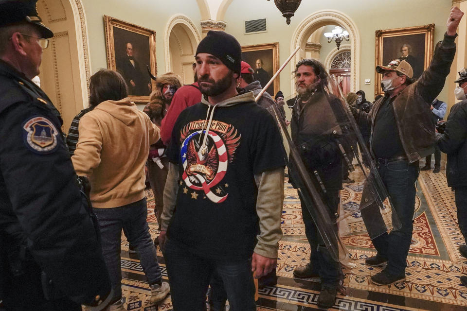 FILE - Rioters are confronted by U.S. Capitol Police officers outside the Senate Chamber inside the Capitol, Wednesday, Jan. 6, 2021, in Washington. Speaker Kevin McCarthy’s decision to unleash a trove of Jan. 6 Capitol attack footage to Fox News’ Tucker Carlson has launched a wholesale rewriting of the history of the deadly siege. Carlson aired the first installment of some 41,000 hours of security footage on his prime-time show and promised more Tuesday. (AP Photo/Manuel Balce Ceneta, File)