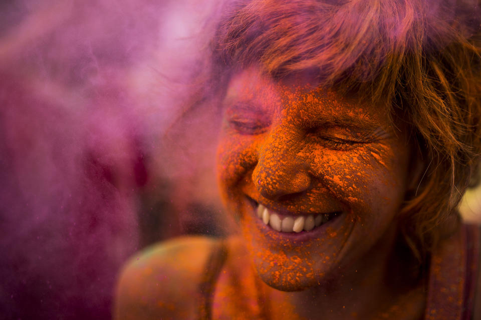 <p>A reveler is covered in colored powder during the Monsoon Holi Festival in Madrid, Aug. 9, 2014. (AP Photo/Andres Kudacki) </p>