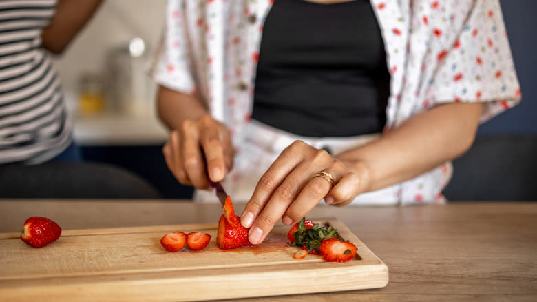 Woman cutting strawberries