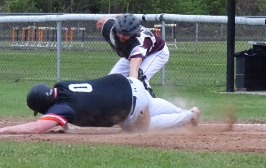 Josh Whaley slides home safely with a Summerfield run against Morence Wednesday. The Morenci catcher is Jacob Reinke.