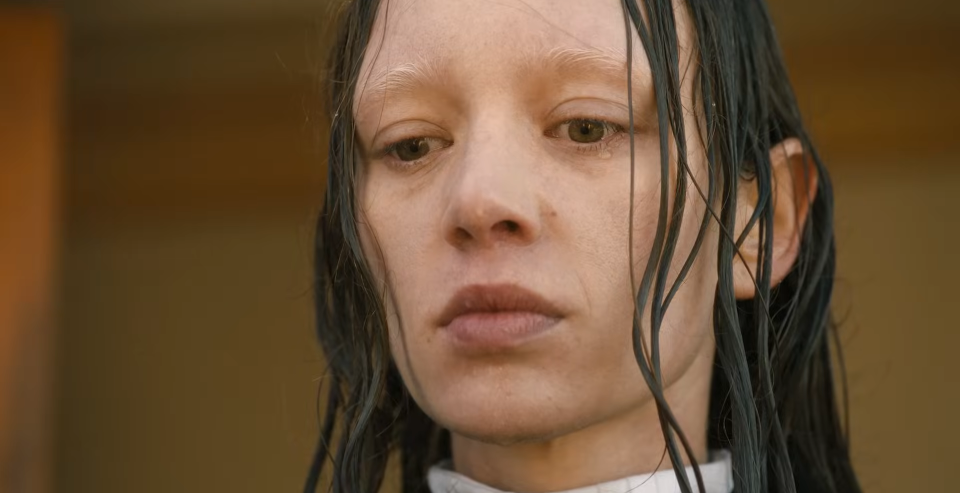 Close-up of a distressed woman with wet hair adhering to her face